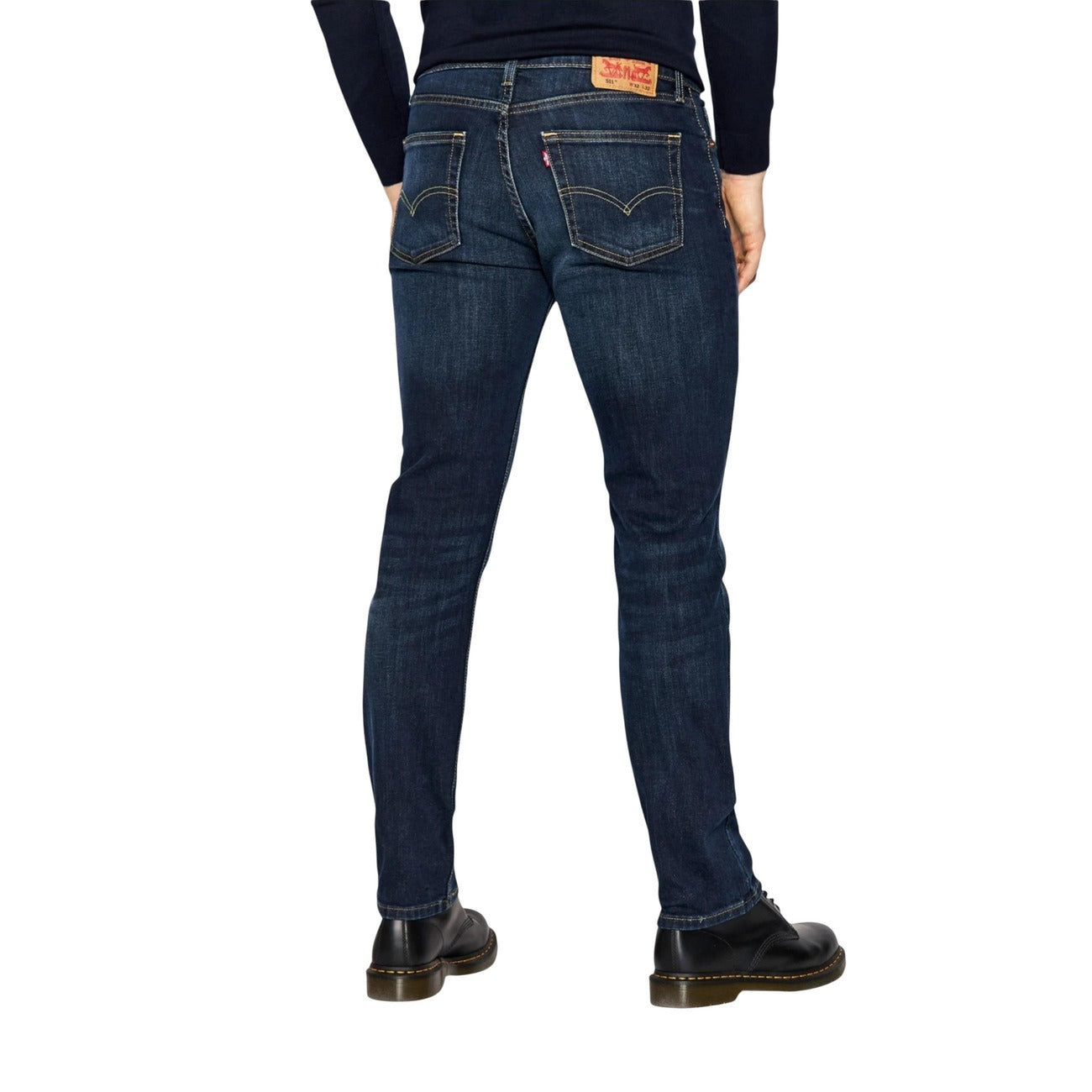 Person wearing dark blue jeans on a white background