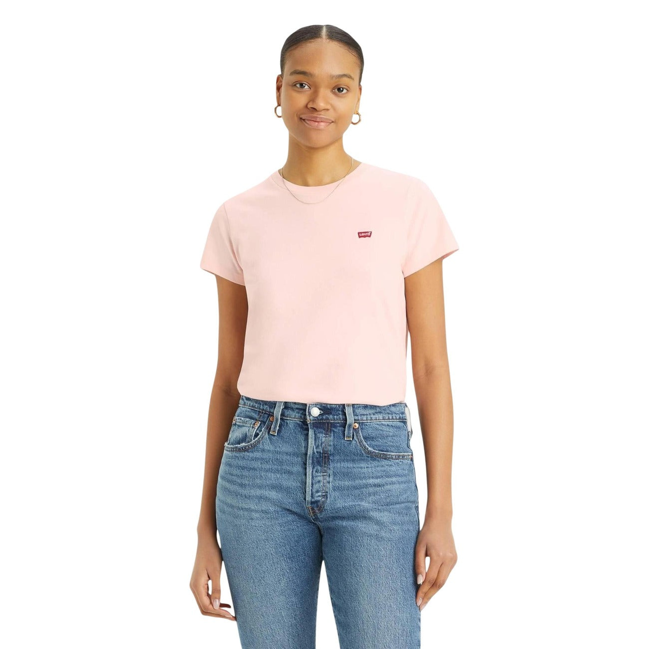 Person wearing a light pink t-shirt and blue jeans on a white background